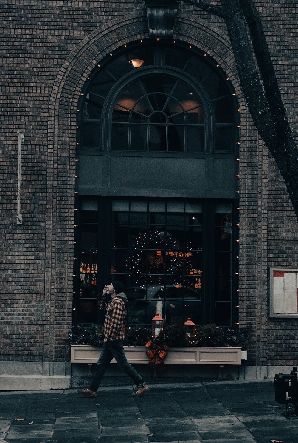 a man walking down the street in front of a building