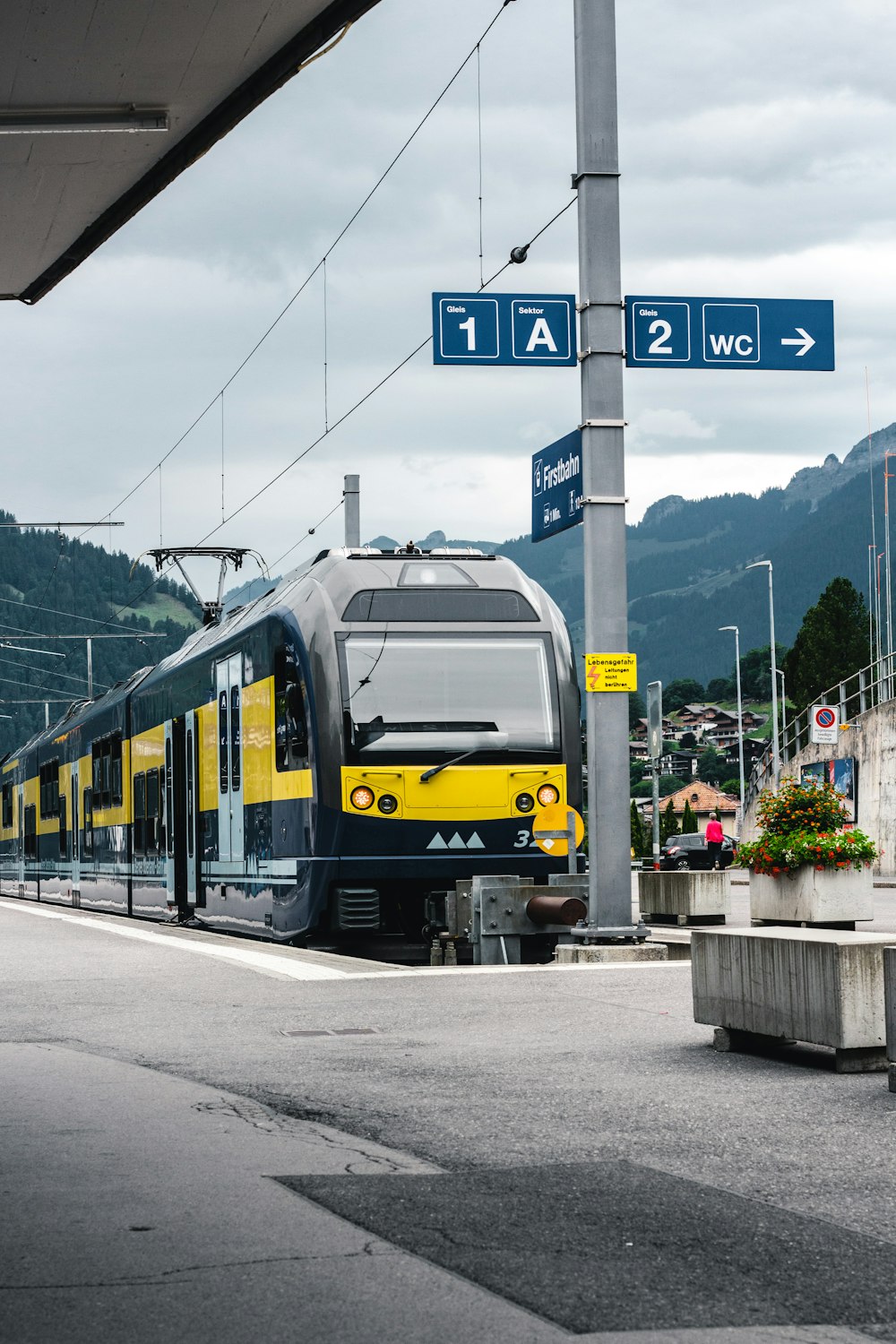 a yellow and black train at a train station