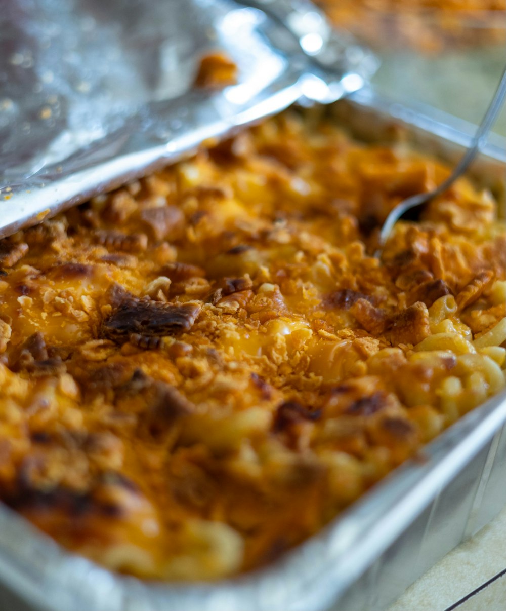 a dish of macaroni and cheese with a spoon in it