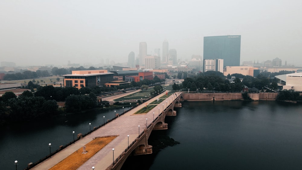 a bridge over a river with a city in the background