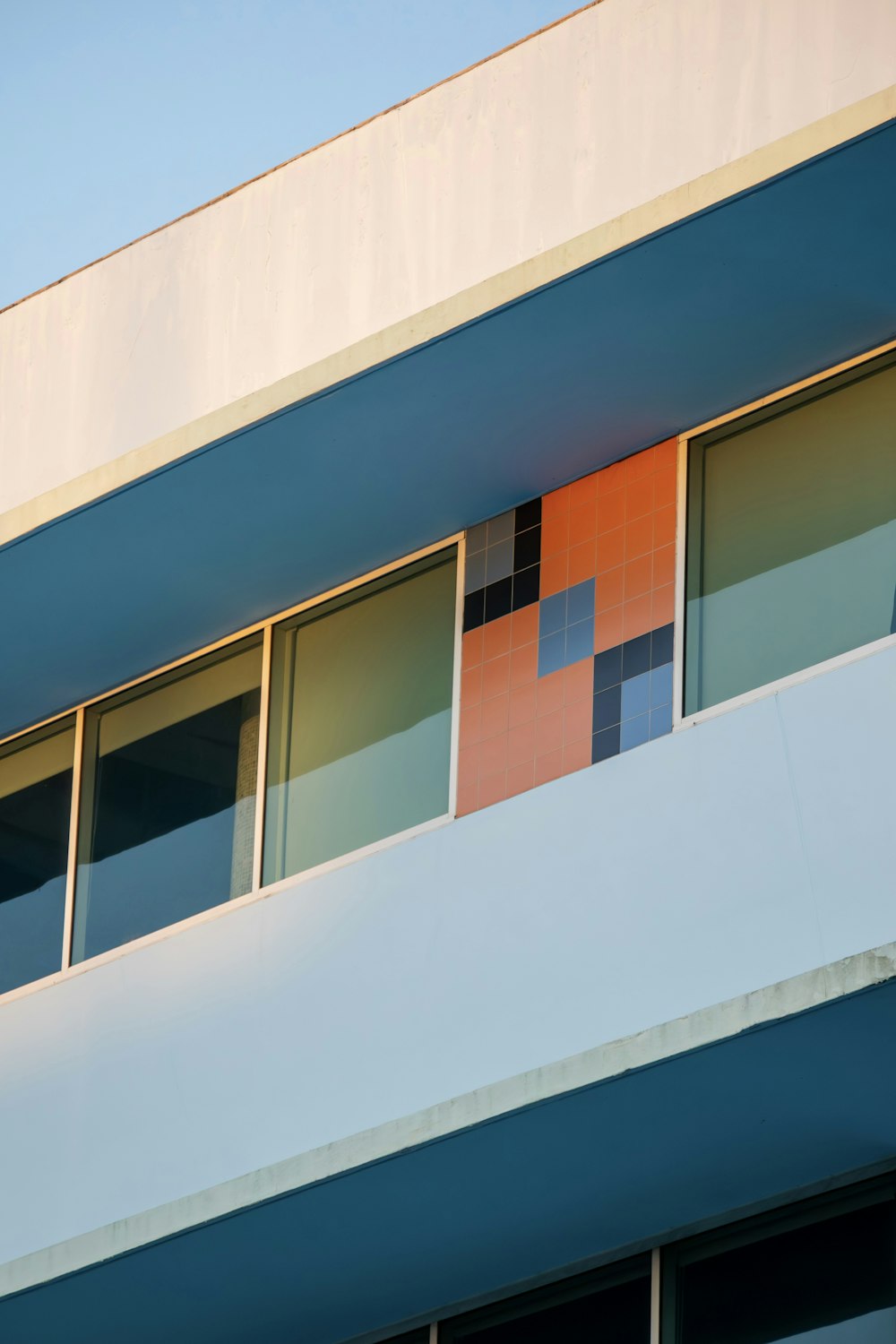 a multicolored building with a clock on the side of it