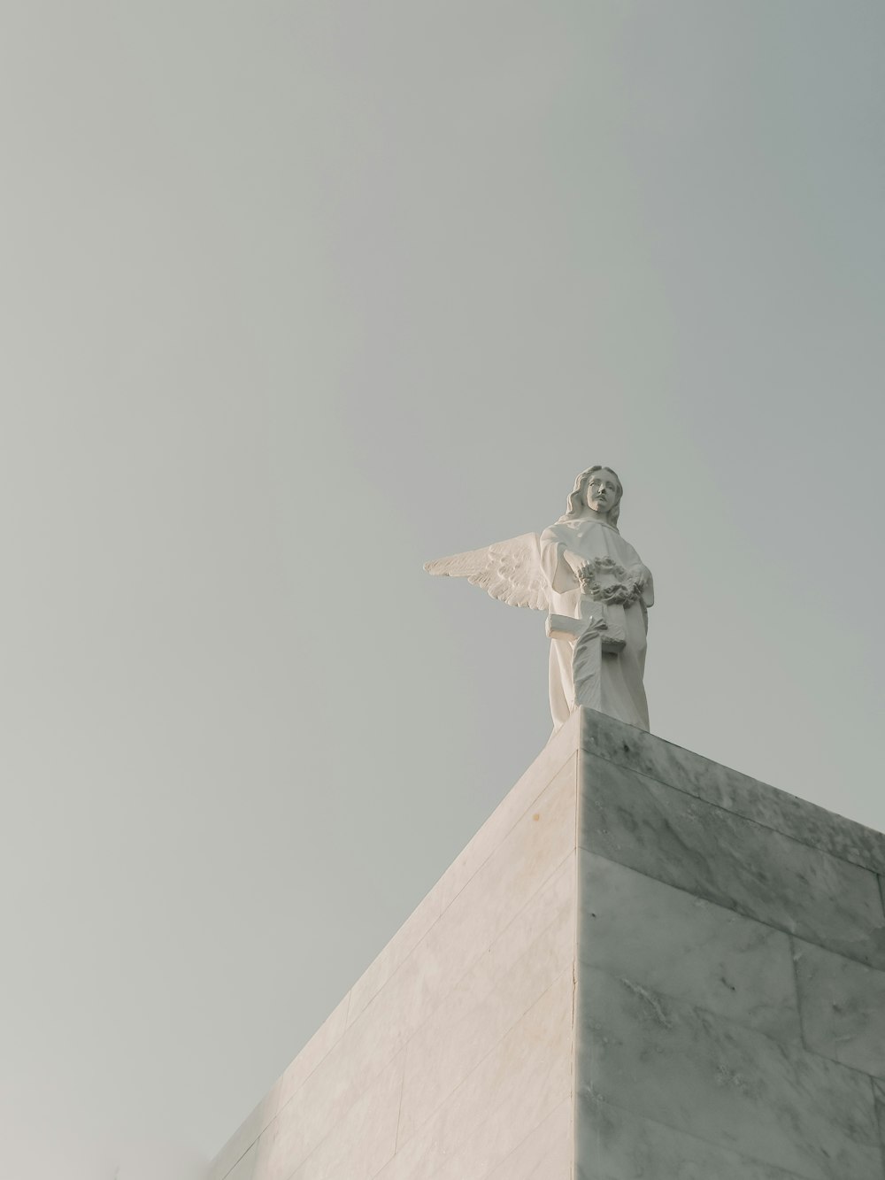 a statue of an angel on top of a building