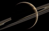 saturn with its rings in the dark sky