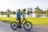 A group of diverse riders practicing e-bike safety techniques in a sunny park setting.
