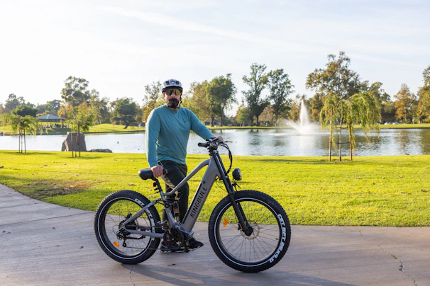 A cyclist riding an e-bike through a sunlit urban park, capturing the essence of modern mobility.