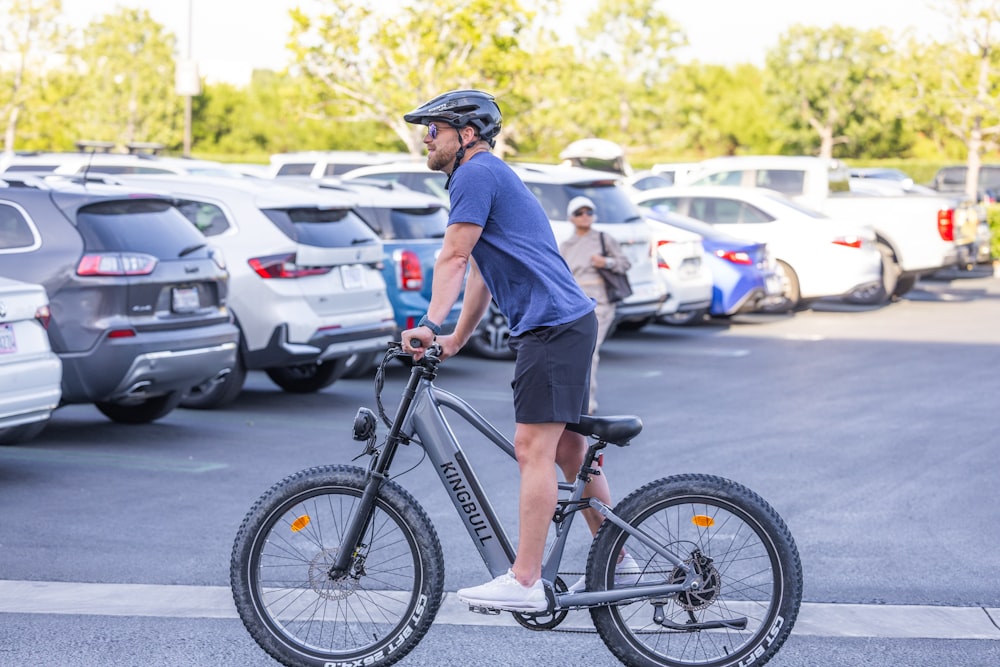 a man riding a bike in a parking lot