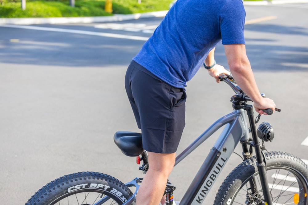 a man riding a bike down a street