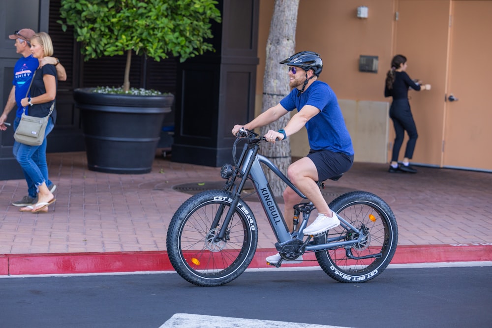 a man riding a bike on a city street