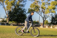 An electric bike rider navigating through a lush green park.