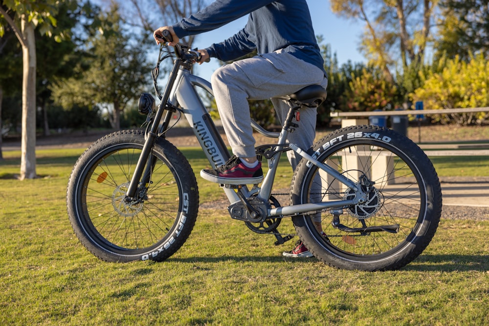 a man riding a bike in a park