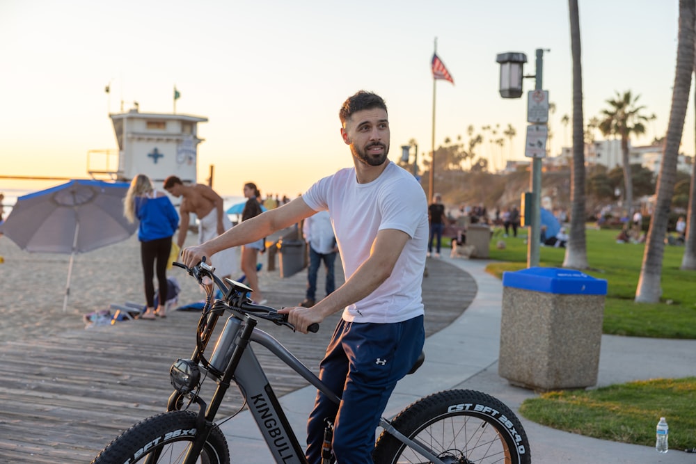 a man standing next to a bike on a boardwalk