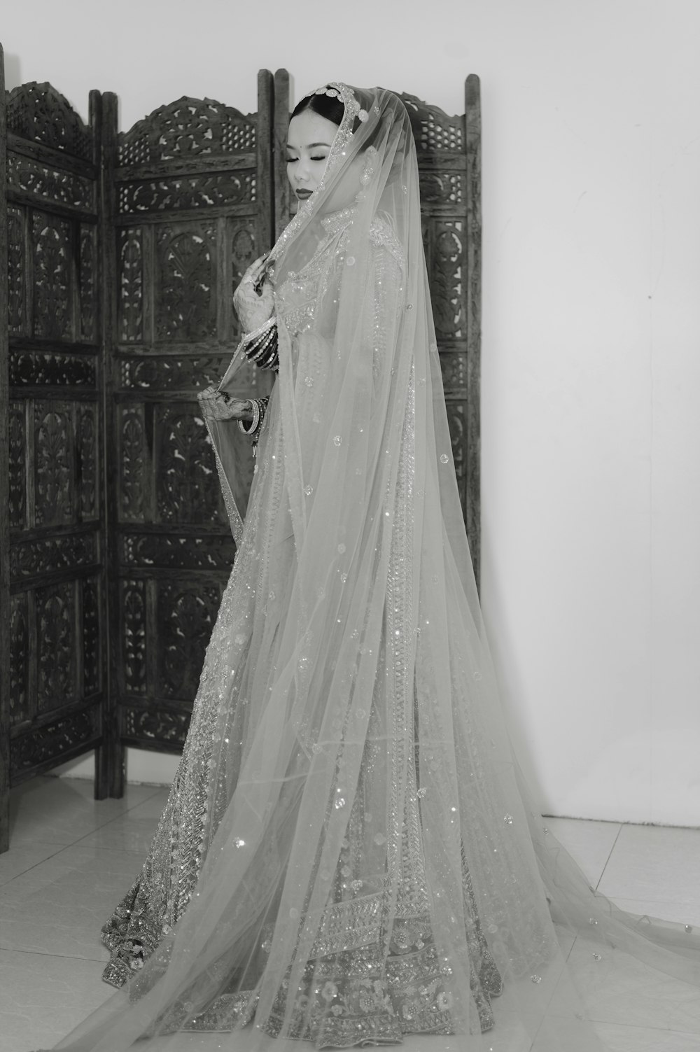 a black and white photo of a woman in a wedding dress