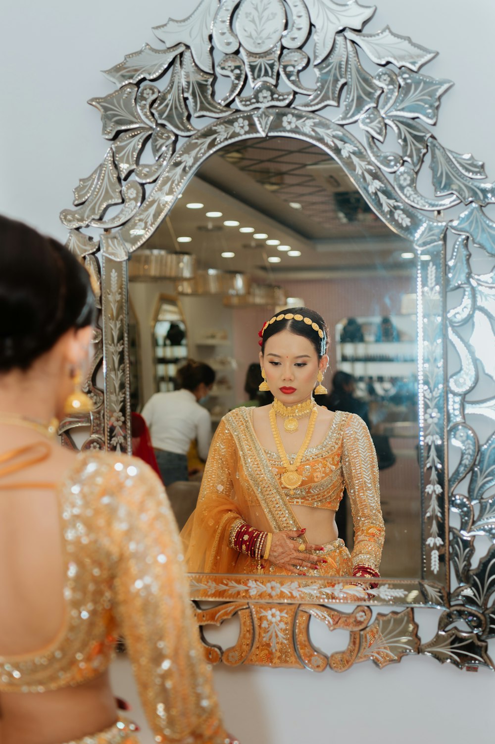 a woman standing in front of a mirror