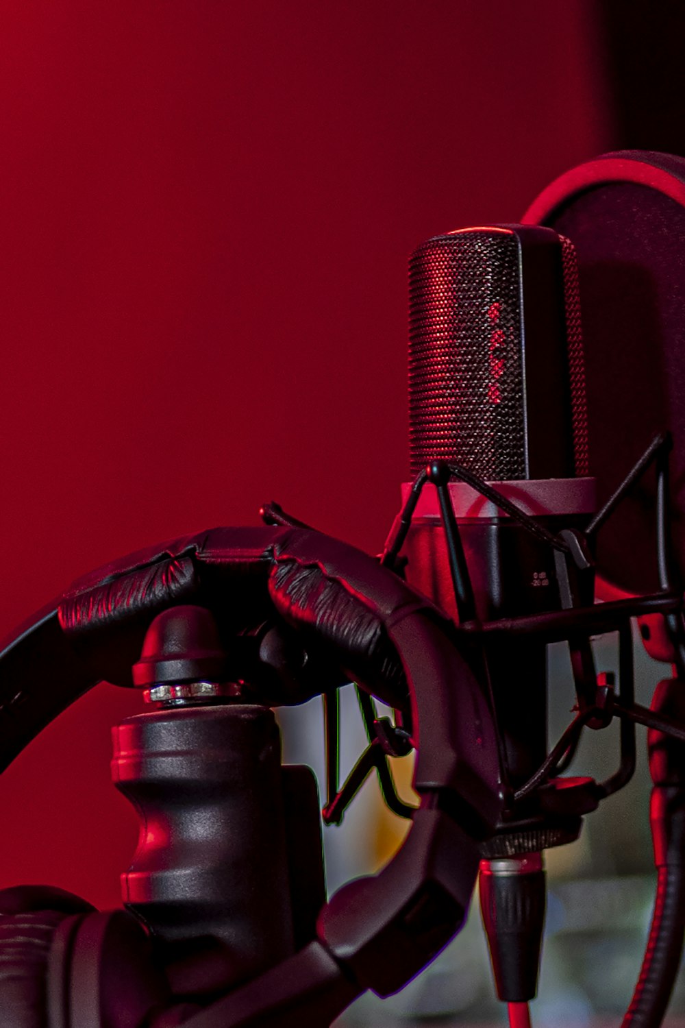 a close up of a microphone with a red background