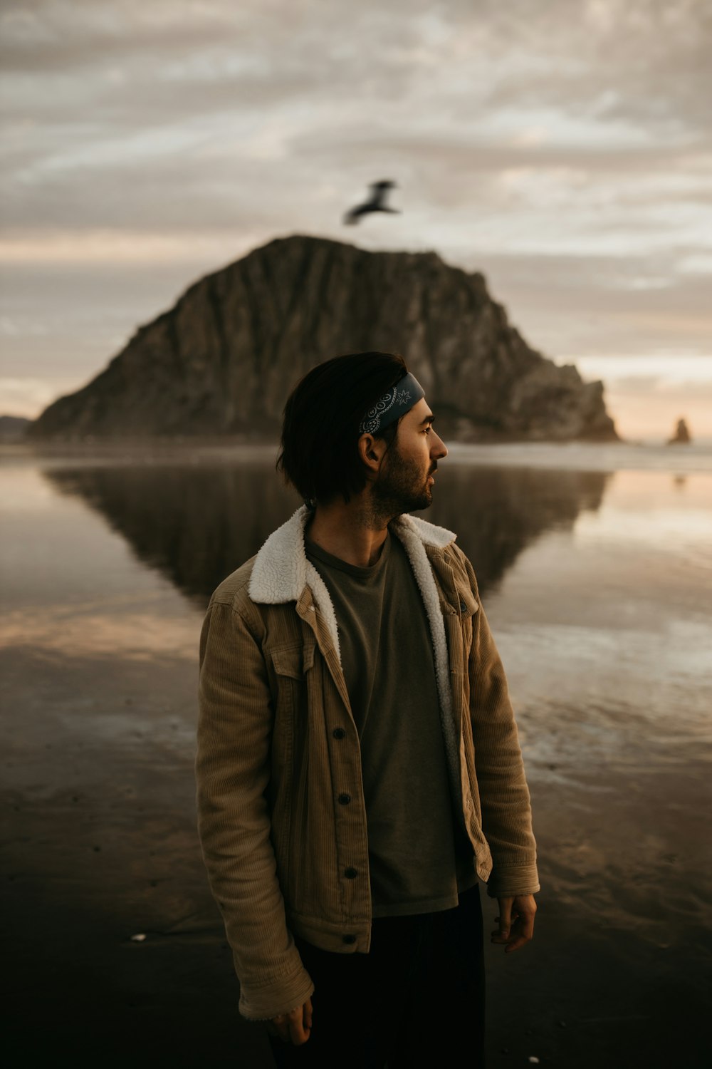 a man standing in front of a body of water