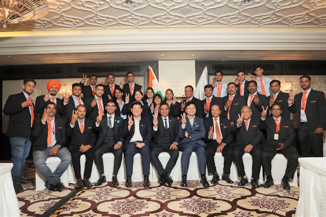 A vibrant image of diverse Indian professionals in business attire, smiling confidently against a backdrop of an airplane wing.