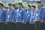 A group of people wearing custom batik shirts at a community event
