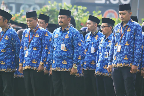 A group of people wearing custom batik shirts at a community event