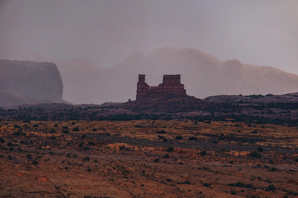 a large rock formation in the middle of a desert