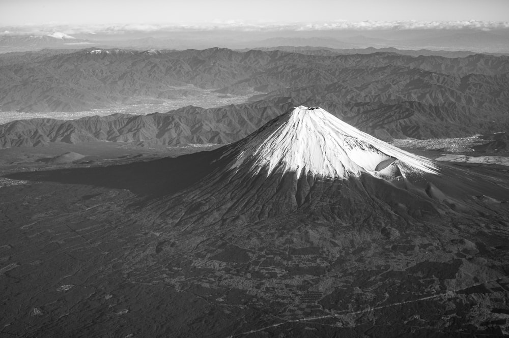 a black and white photo of a snow covered mountain