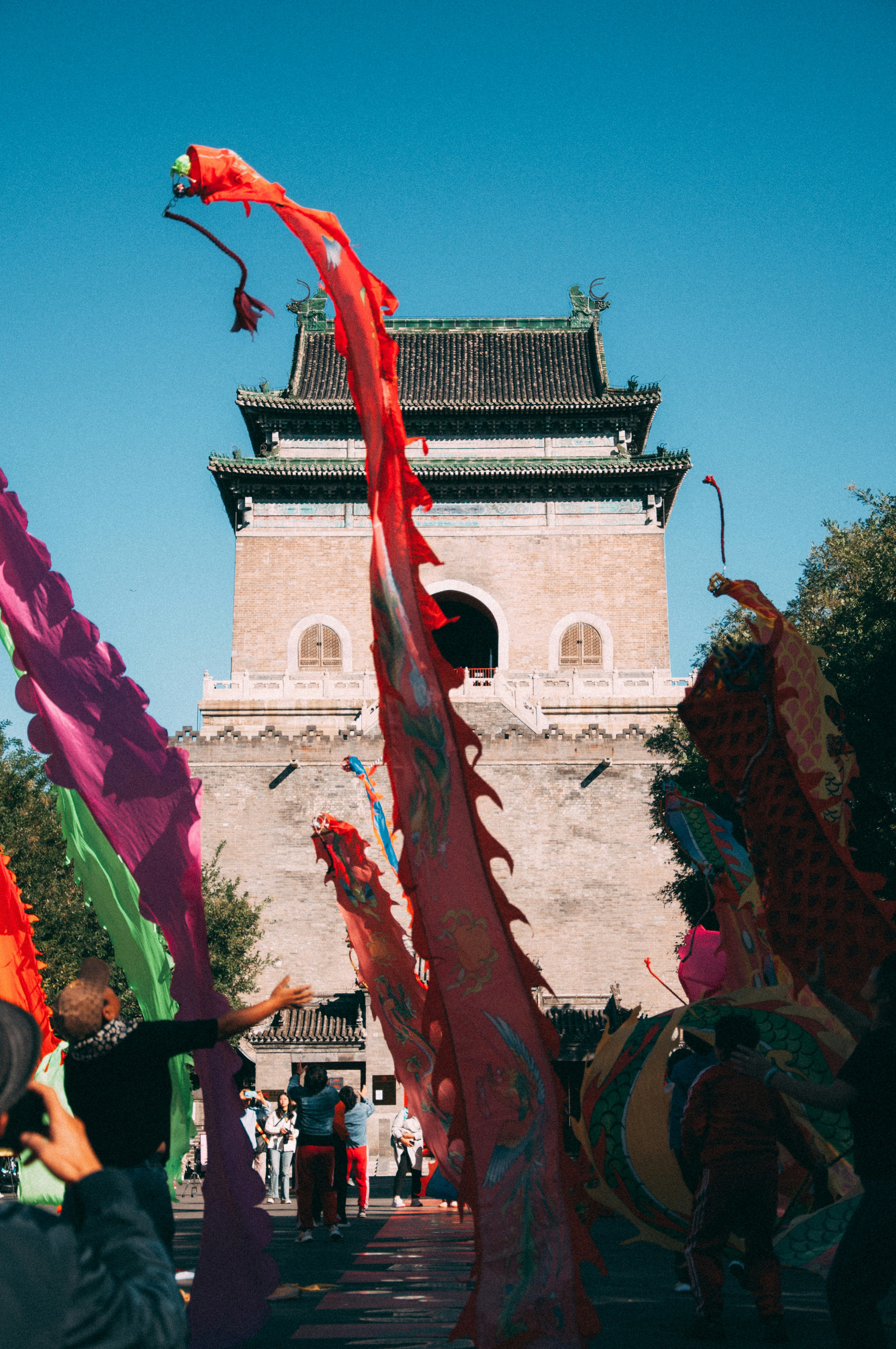 a group of people standing around a tall building