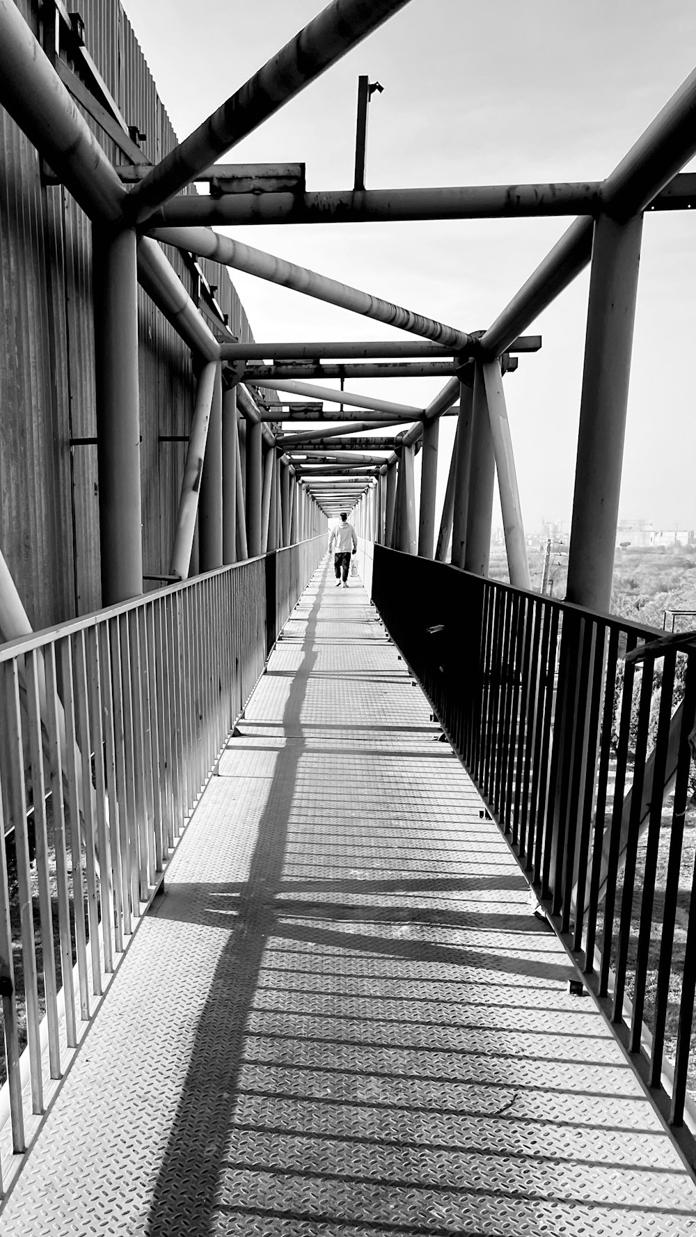 a person walking across a bridge over water