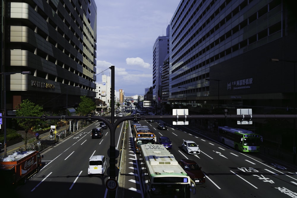 a city street filled with lots of traffic next to tall buildings