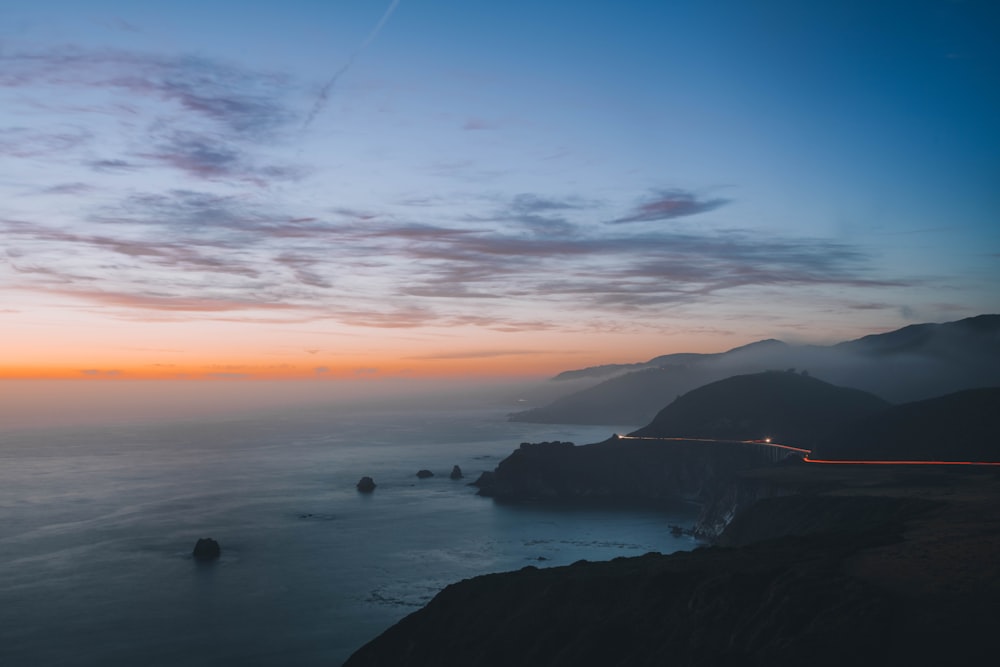 a scenic view of the ocean at sunset