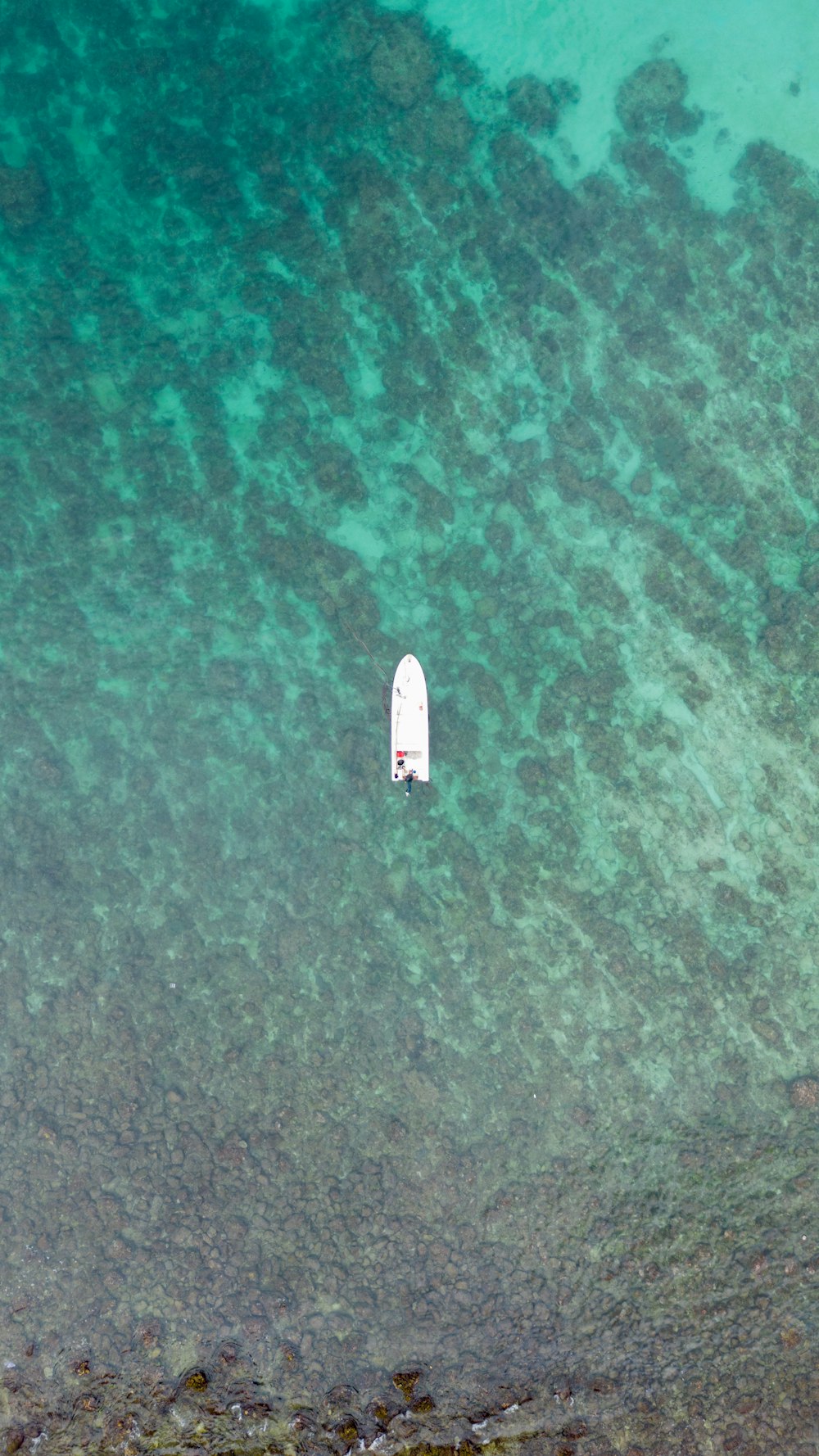 an aerial view of a surfboard in the water