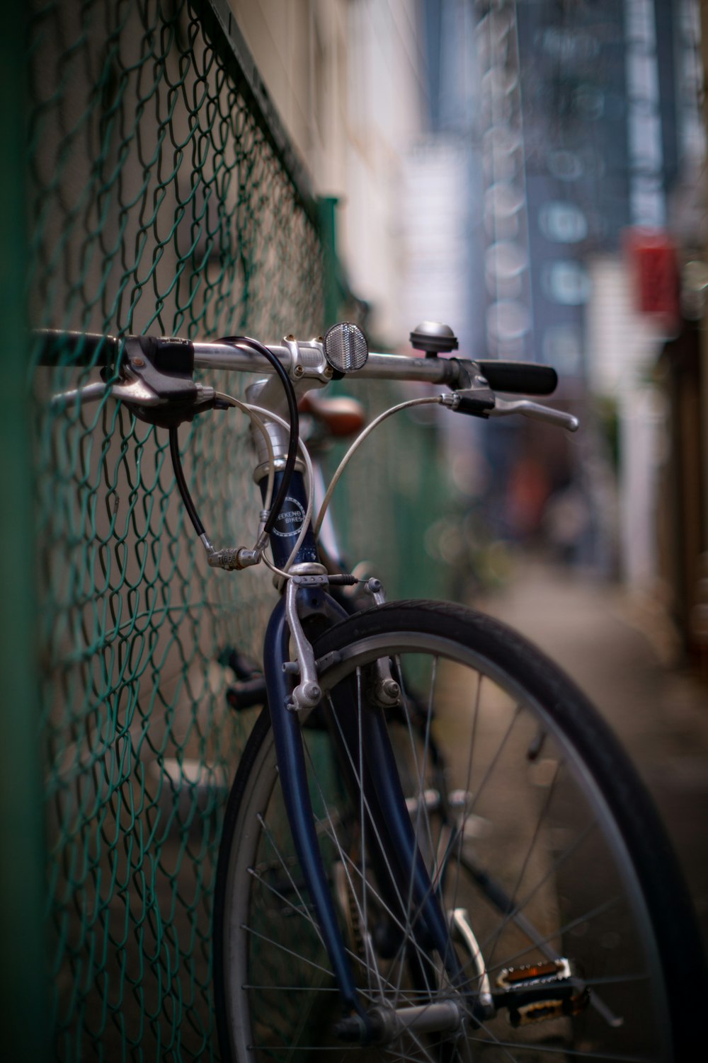 a close up of a bike parked next to a fence