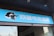 A building entrance features a vibrant blue sign with white Chinese characters and a stylized orca logo in black and white. The overall appearance suggests an establishment focused on eSports or digital activities.