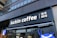 A modern storefront features the sign 'luckin coffee' in bold, white letters on a black background. The sign also includes Chinese characters next to it. The facade of the building is sleek and urban with floor-to-ceiling windows on the upper floors.