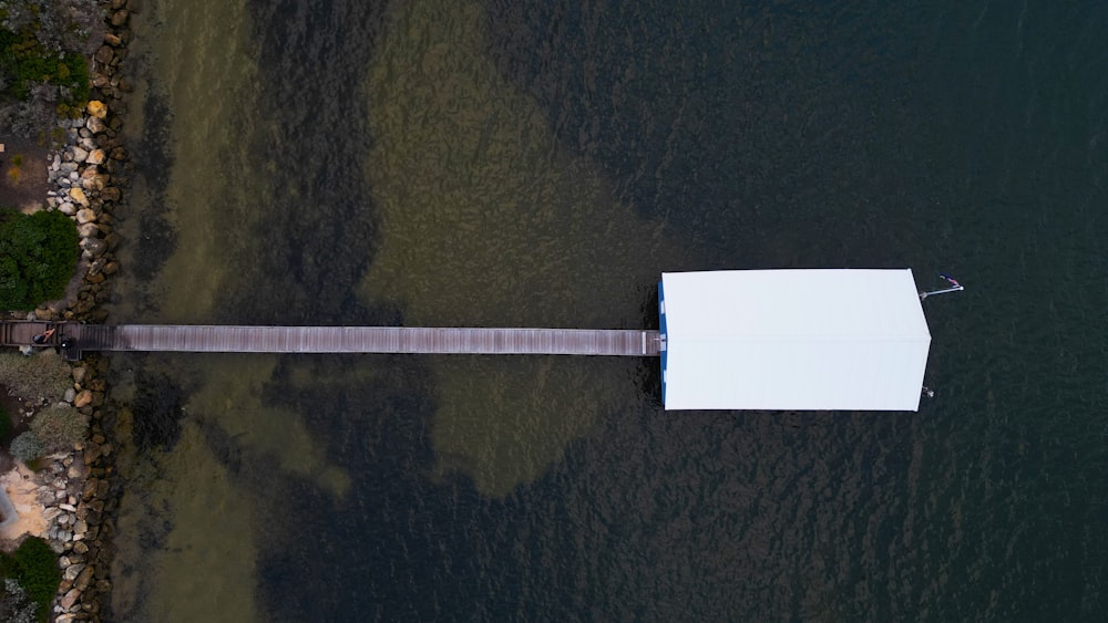 an aerial view of a dock in the water