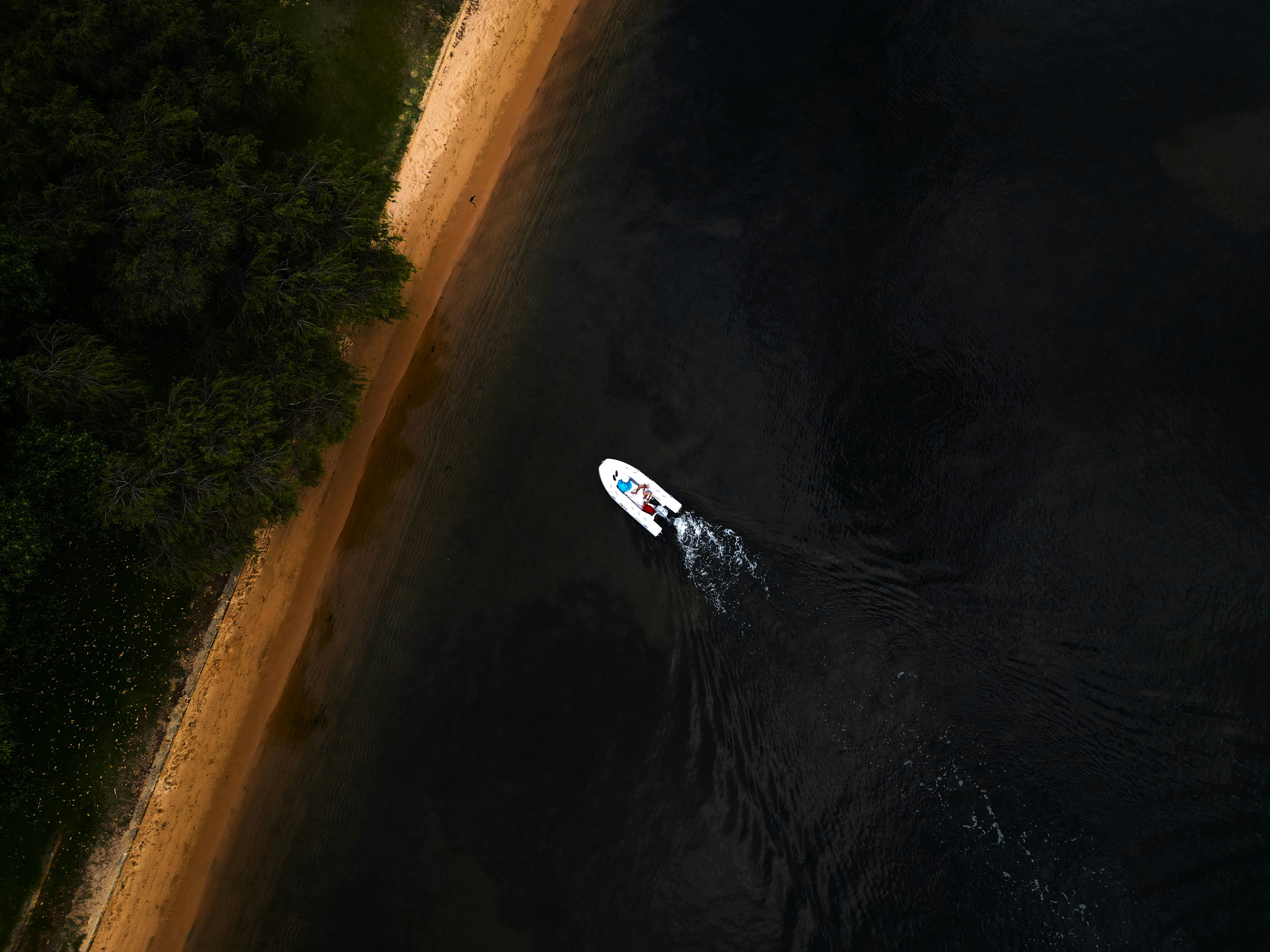 an aerial view of a boat on the water