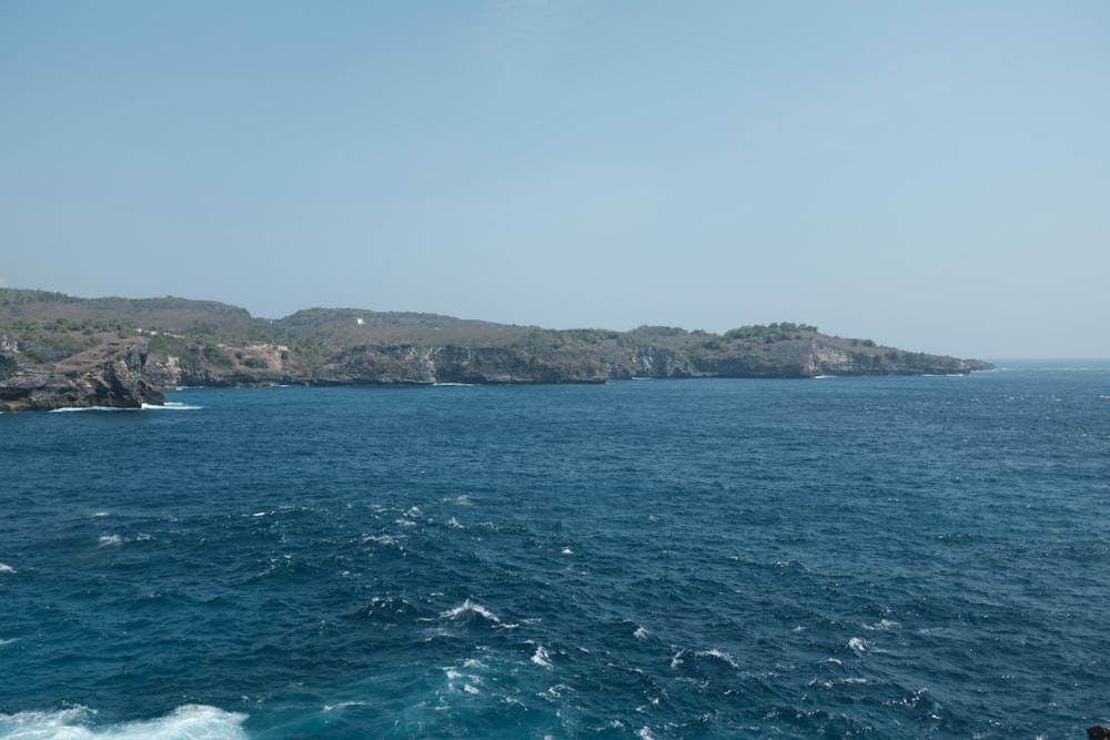 a body of water with a small island in the distance