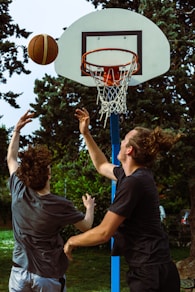 a couple of men playing a game of basketball