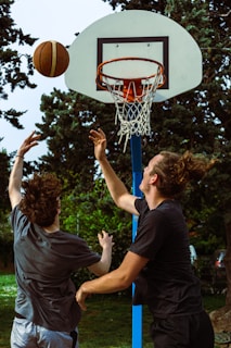 a couple of men playing a game of basketball