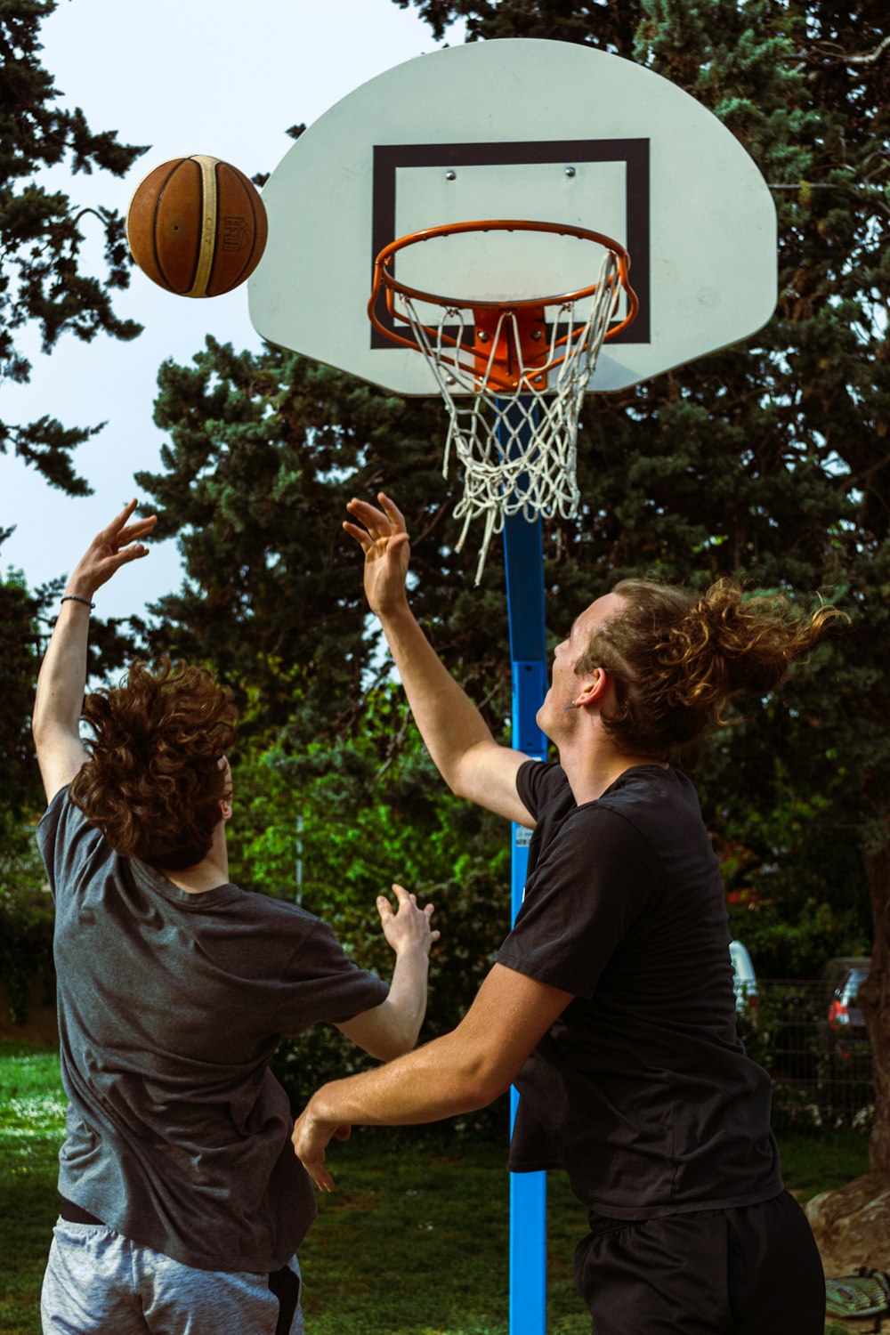 a couple of men playing a game of basketball