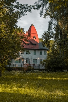 a large white house with a red roof