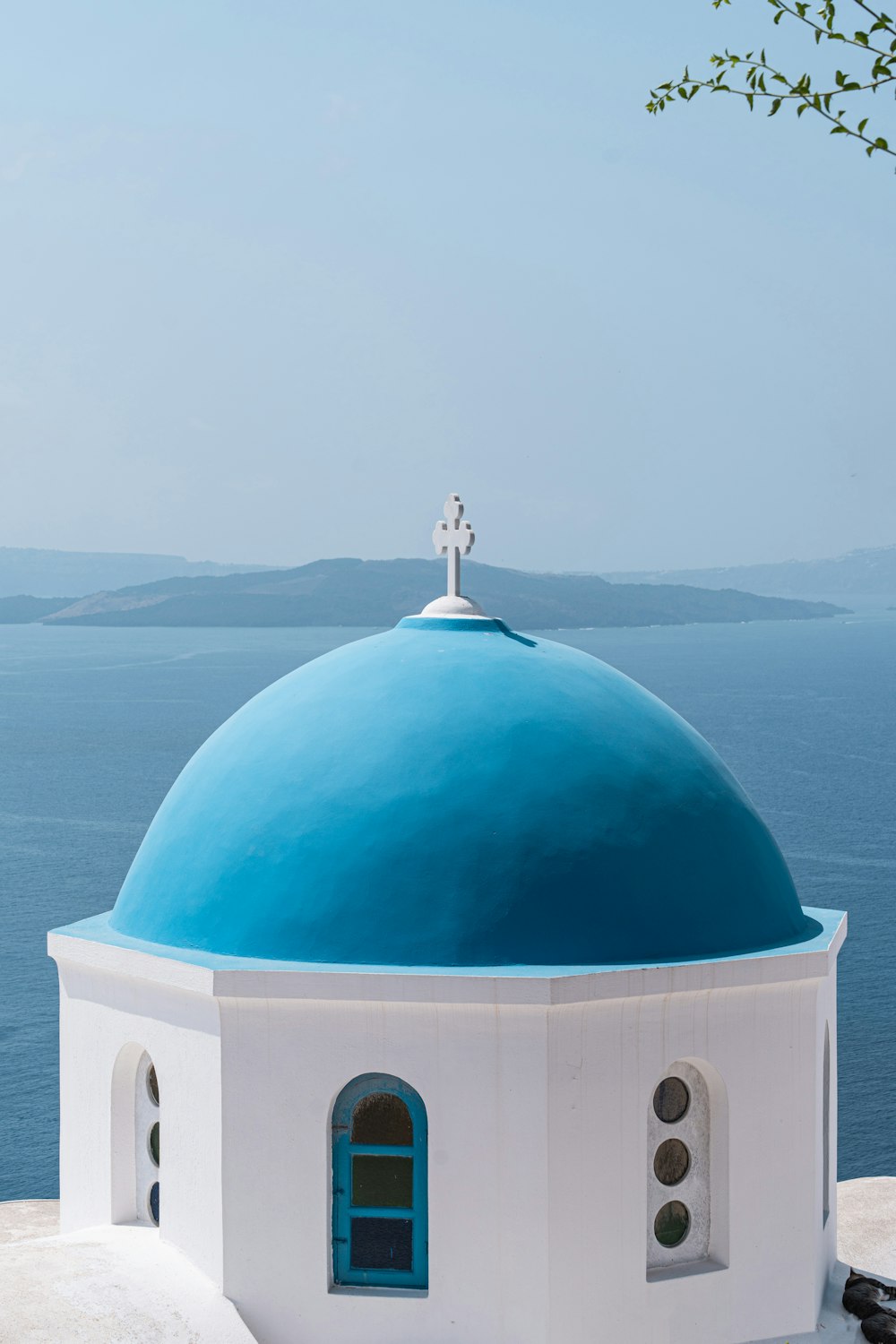 a white and blue building with a cross on top