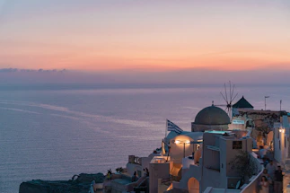 A warm sunset over a peaceful Greek island coastline, symbolizing hope and care for the environment.