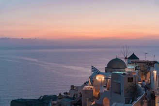 A serene sunset over the Greek island coastline symbolizing harmony with nature.