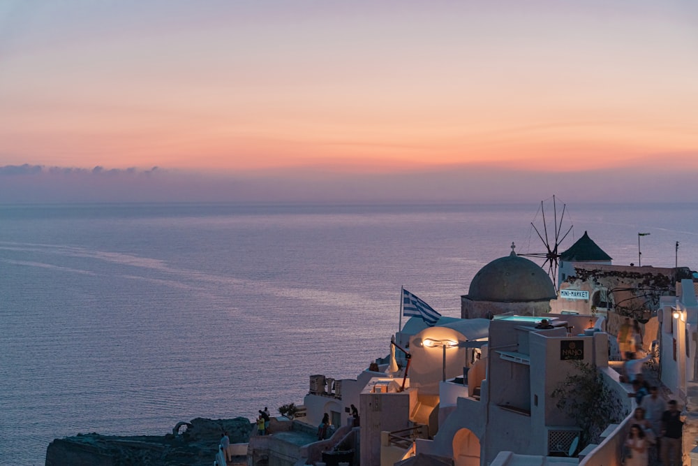 a sunset view of the ocean and buildings