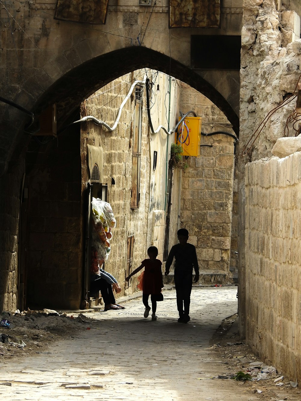 a couple of people that are walking down a street