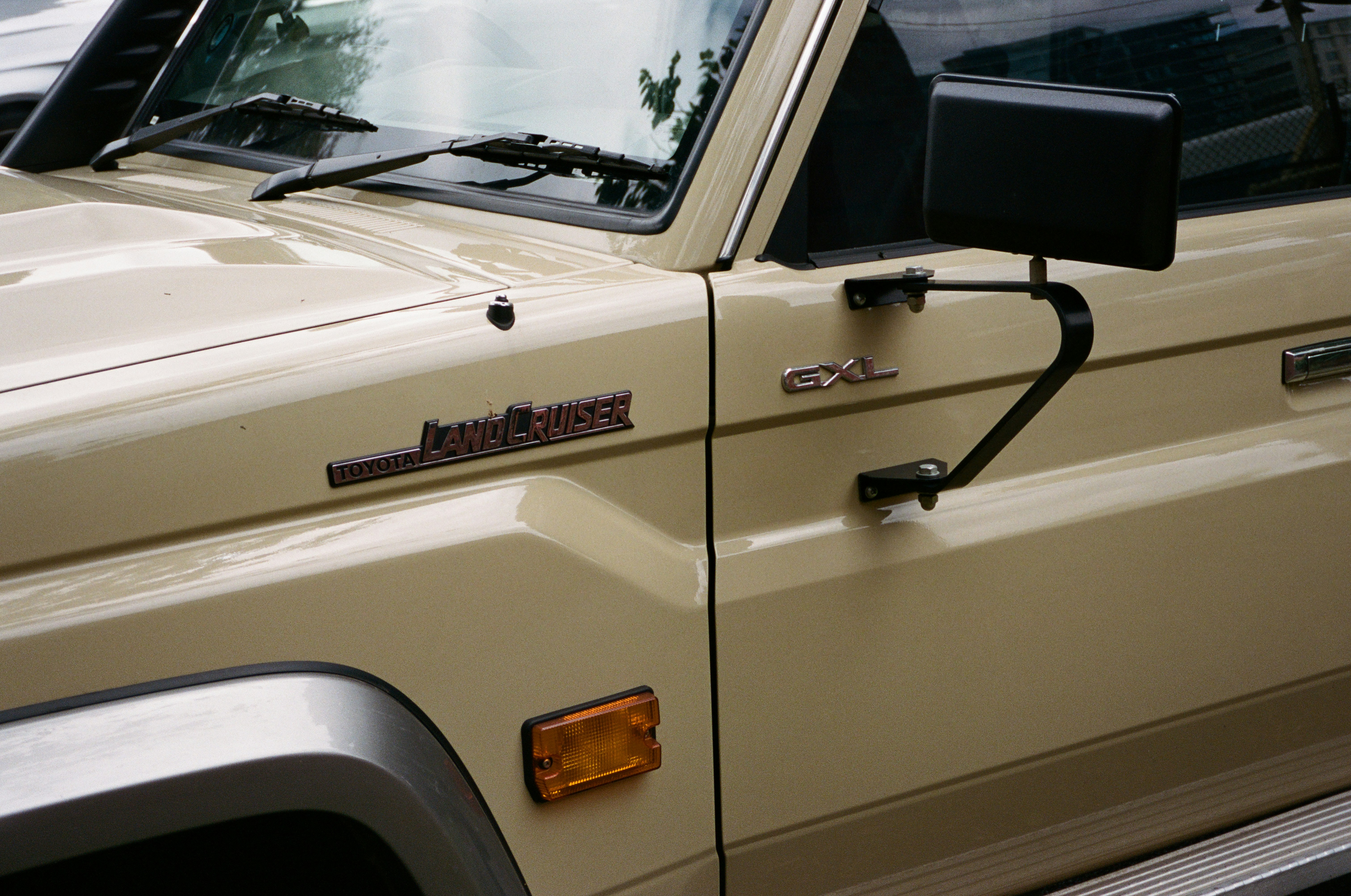 a beige truck parked in a parking lot