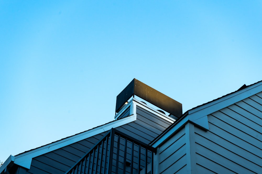 a building with a metal roof and a sky background