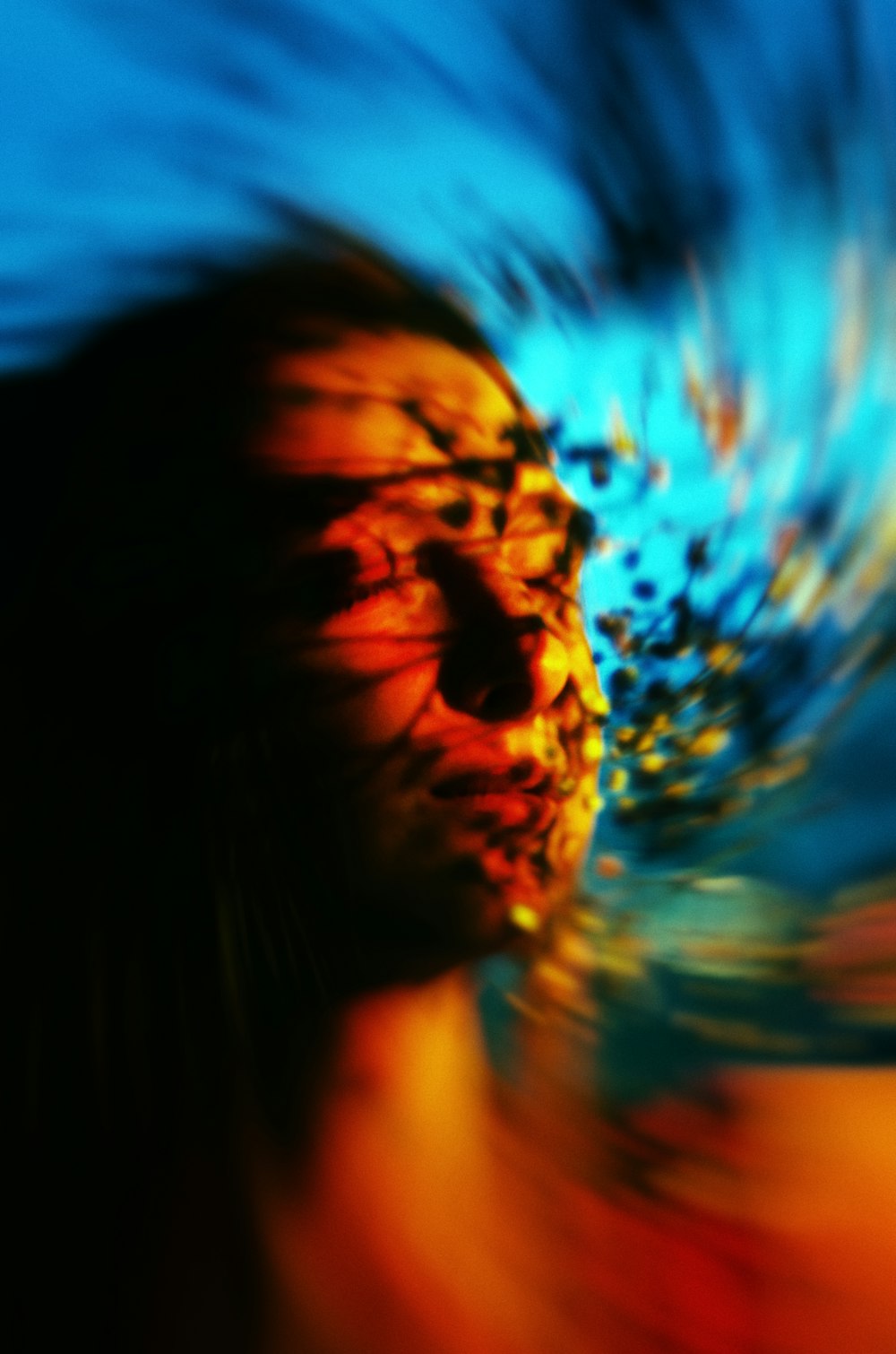 a blurry image of a woman's face and hair