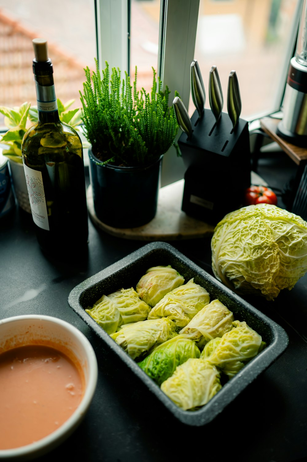 a table topped with a tray of food next to a window