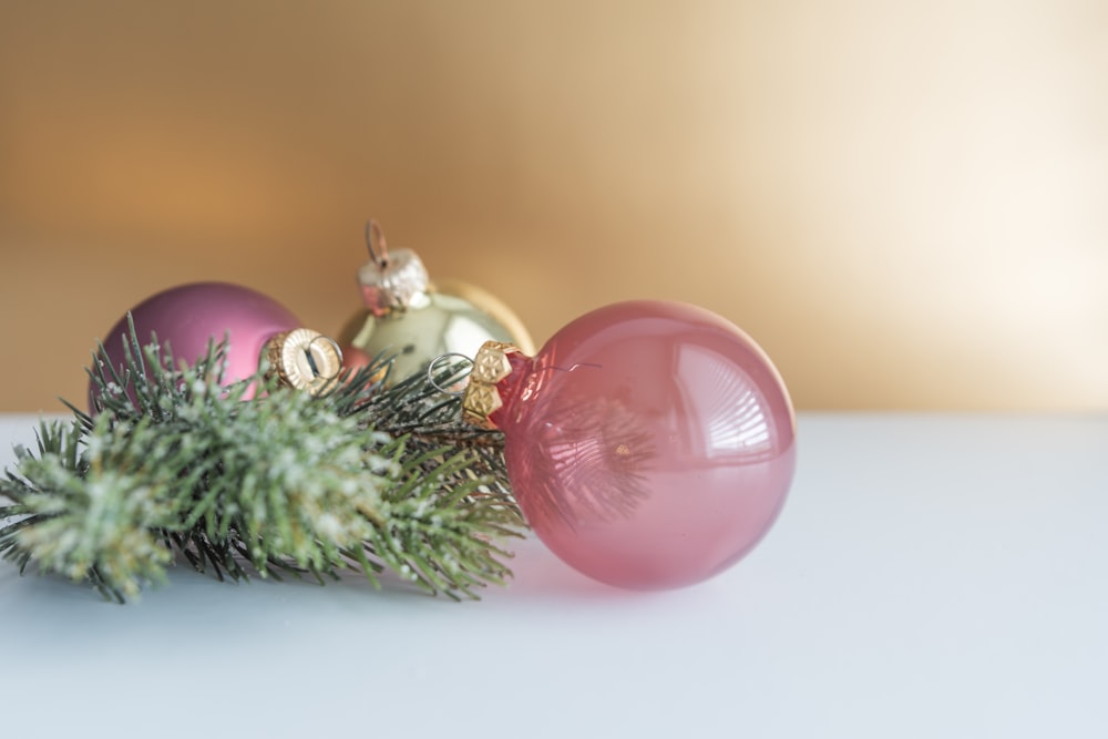 a close up of three ornaments on a table
