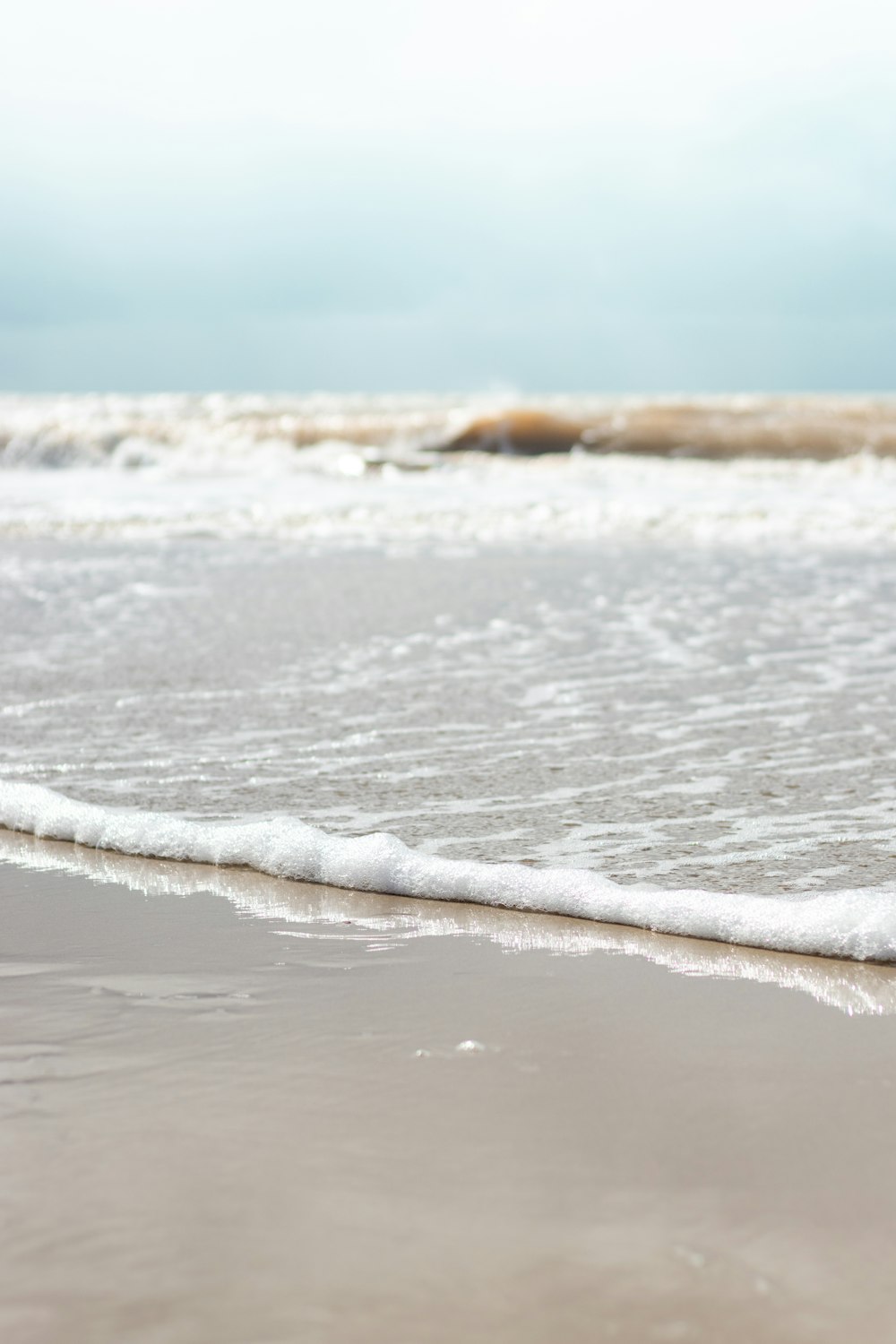 a close up of a wave on a beach